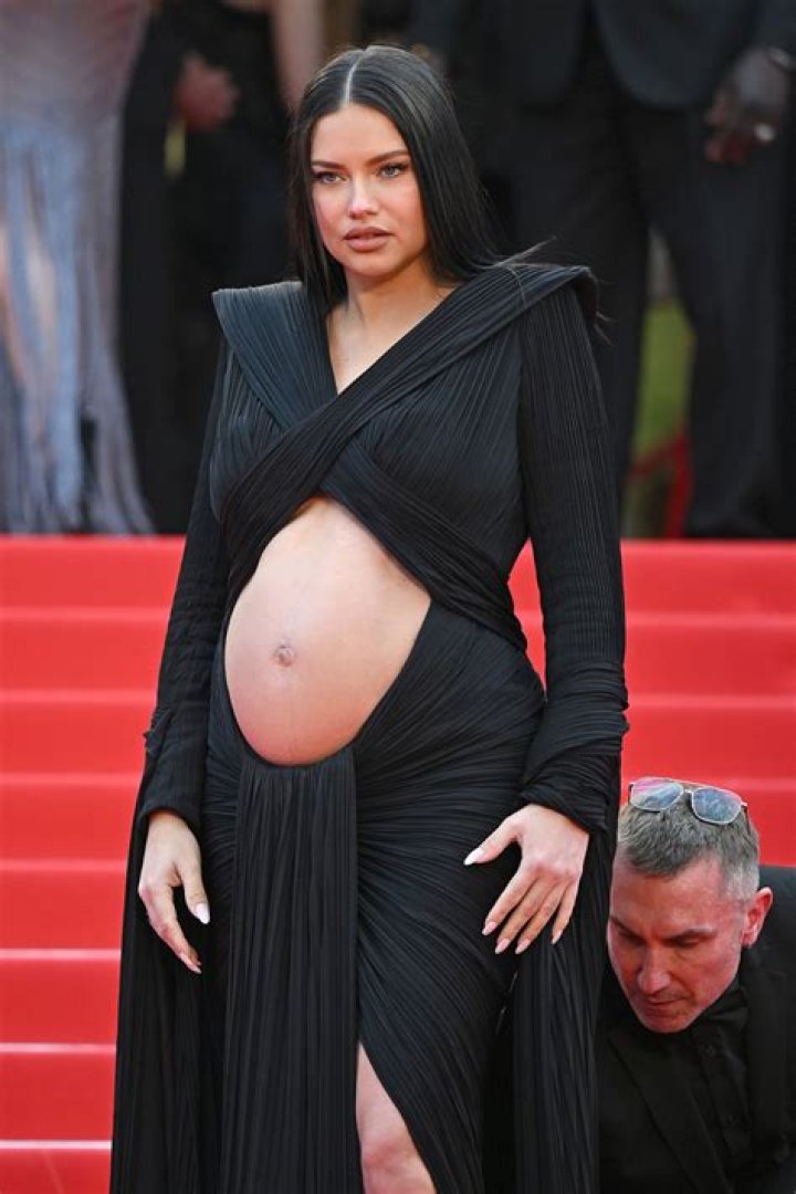 Pregnant Adriana Lima in a Black Midsection Cut Dress at Cannes Showing off her Belly Bump!